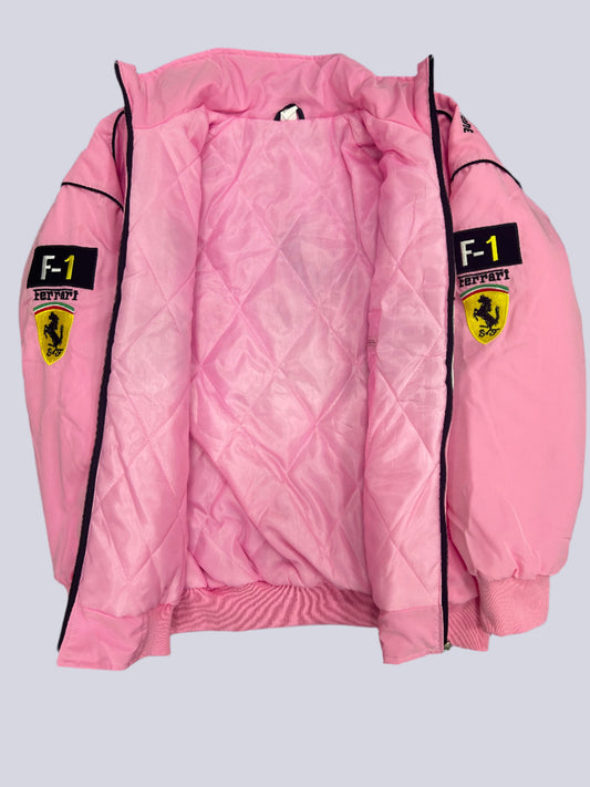 Pink quilted jacket with Ferrari logo on a dark textured surface