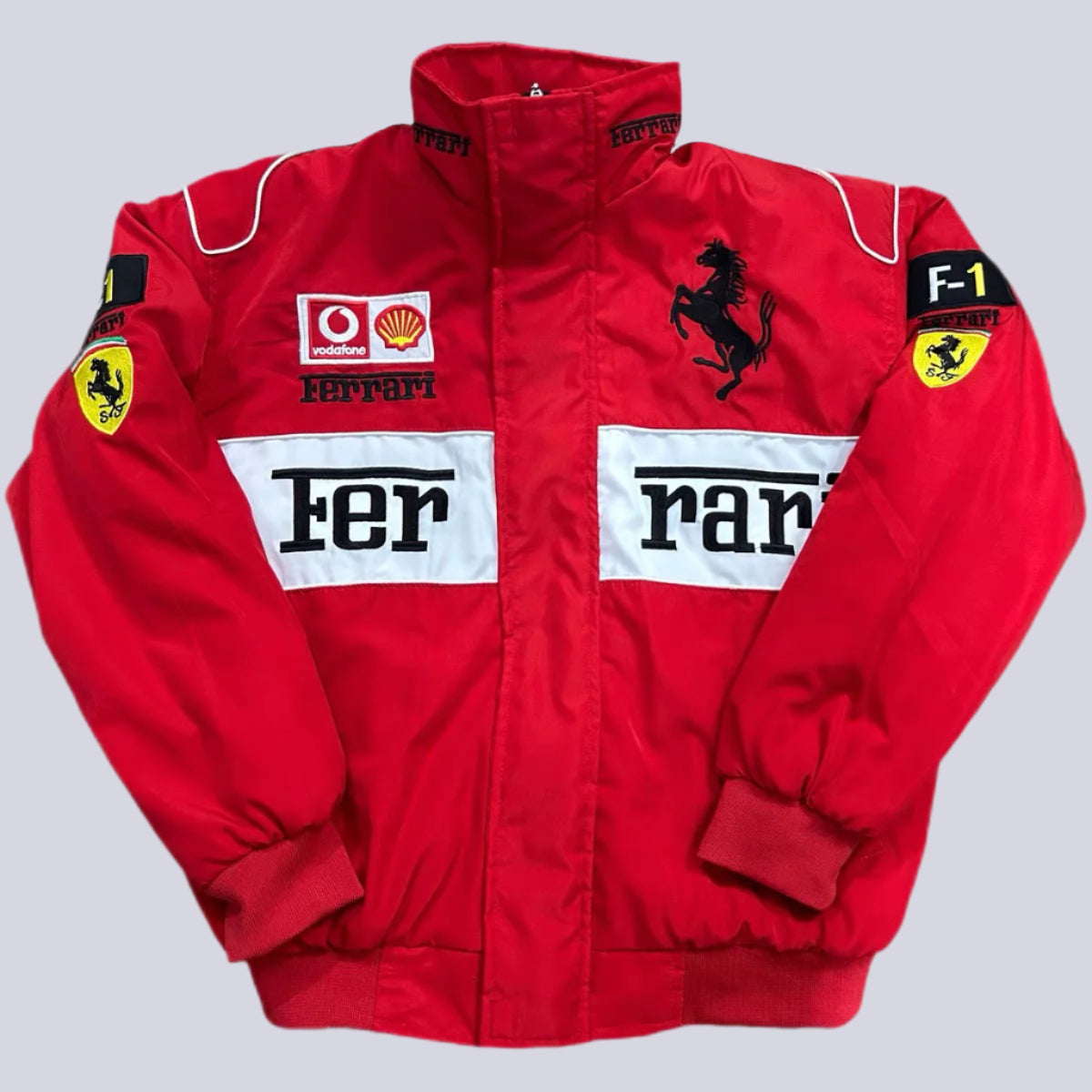 Red Ferrari racing jacket with various logos on a white background