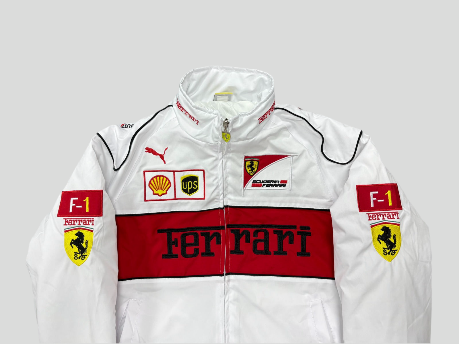 White jacket with Ferrari logos and branding on a gray background